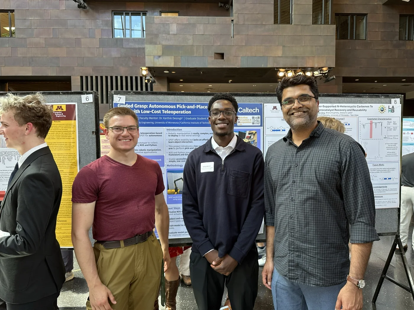 Salviya with research mentors in front of his robotics research poster